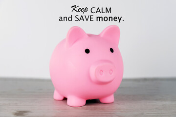 Finance inspirational motivational quote - Keep Calm and save money. With pink piggy bank on the table on white background. Financial planning and investment concept. - Powered by Adobe