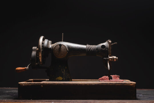 Retro style sewing machine on the dark background.