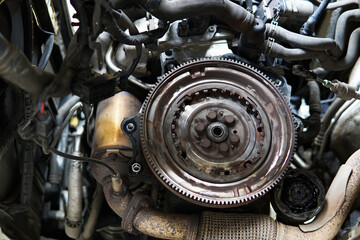 Flywheel mounted on a modern engine. Engine and transmission repair. Car service and spare parts.