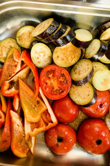 Close-up top view of slices of various raw chopped vegetables