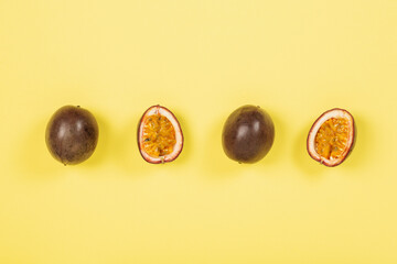Passion fruits on a yellow background, top view, copy space	