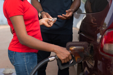 nigerian driver paying for fuel