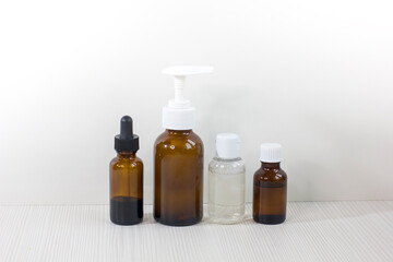 Various glass bottles for cosmetics, essential oils or other liquids isolated on a white background.