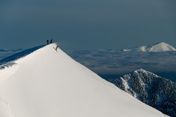 amazing view of winter landscape and top of mountain slope with skier sliding down along it