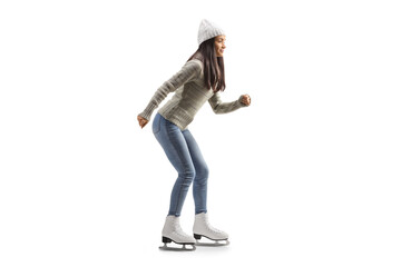 Full length profile shot of a young casual woman ice skating