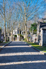 Fototapeta na wymiar Paris, the Pere-Lachaise cemetery, cobbled alley with graves in winter 