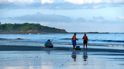 Fishermen on the beach in Tamarindo, Costa Rica, at sunrise