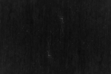 Old black metal sheet with scratches and spots for texture background