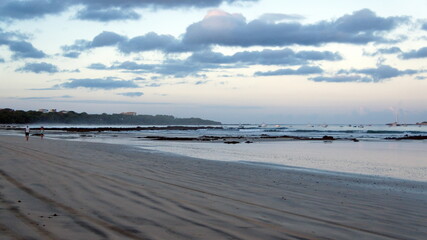 Rocks exposed on the beach, just after sunrise, in Tamarindo, Costa Rica