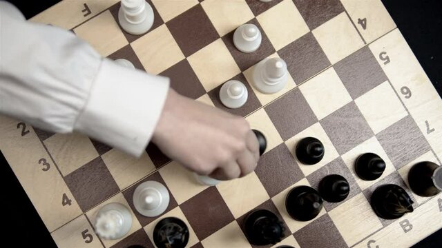 Hand playing chess. Pawn move. political games. global government. Сhess board game. Top view. 
