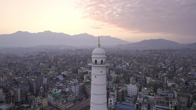 Sunset aerial view flying around the Dharahara Tower looking over Kathmandu Nepal.
