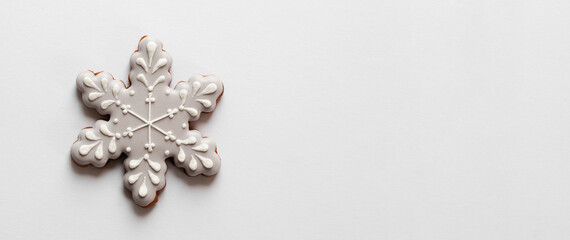 Gingerbread cookie in snowflake shape isolated on white background