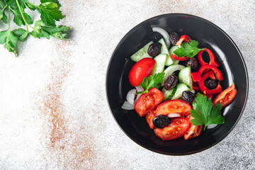 vegetable salad tomato, cucumber, olives, onion, pepper fresh spring healthy meal food snack on the table copy space food background