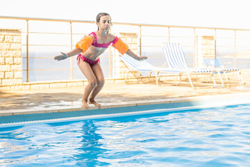 little girl having fun in the pool