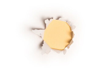 A hole in a white paper on a yellow background.