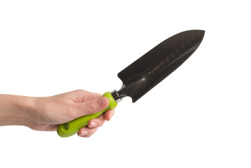 Little green shovel in woman hand isolated on white.