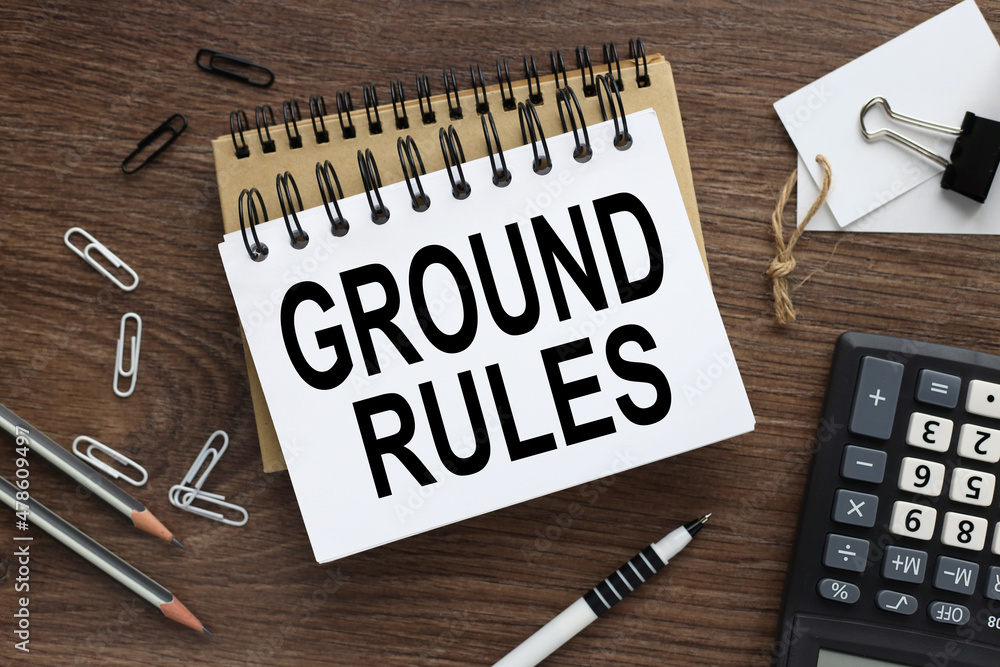 Poster ground rules. two notebooks with a spring on a wooden background with a pencil calculator pen busine