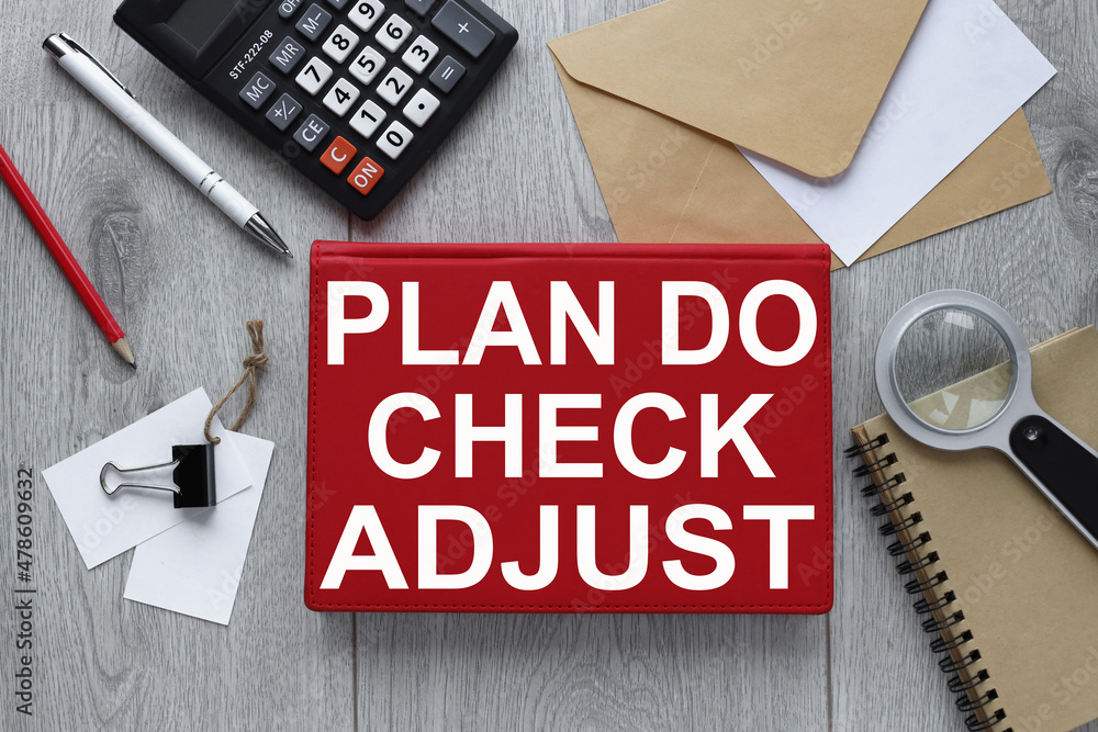 Poster plan,do,check and adjust . red notepad on wood background with envelope and calculator