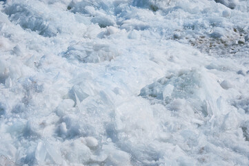 Melting ice on the river in spring. Ice drift time. Natural structure.