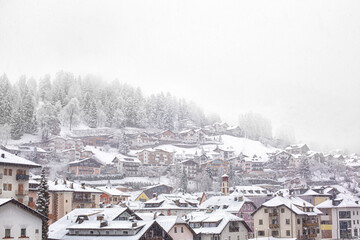 Small Alpine town in a winter snowy day. Ortisei, Italy - January 6, 2022. South Tyrol, Italy, Europe.