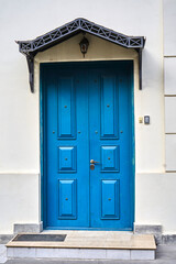 Fototapeta premium old house white wall with blue door