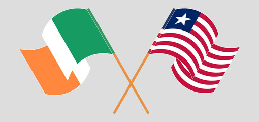 Crossed and waving flags of Ireland and Liberia