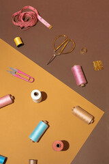 Creative sewing concept with threads, needles, scissors and measuring tape.DIY background idea.Personal inventiveness.
