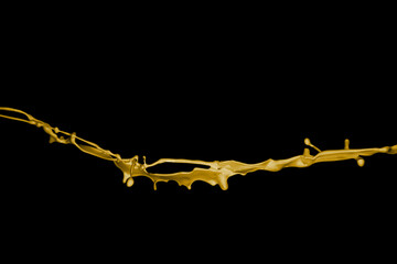 Fototapeta premium Yellow paint splashes, isolated on black background