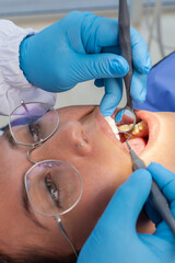 Young woman being examined by the dentist at the dental clinic. Concept of healthy teeth and medicine