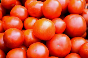 Red ripe tomatoes background. Market, store shelves.