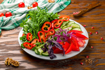 slicing fresh vegetables on a plate on wooden table