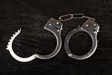 open handcuffs closeup punishment for a crime..