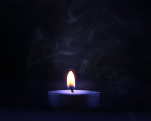 Burning candle in the dark