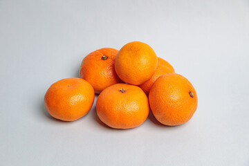 Several tangerines on a blue background.