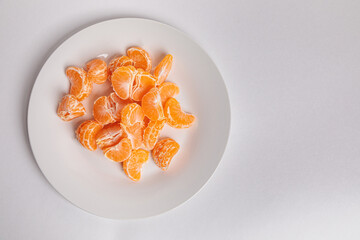 Tangerine slices on a white plate.