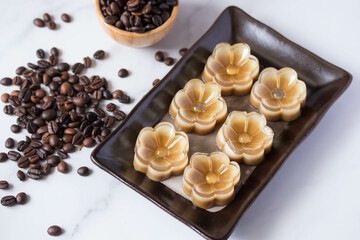 Flower shaped coffee jelly in black plate, Thai dessert
