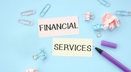 Paper writing word financial services on blue background