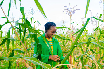 pretty agriculturist smiles as working on her crops