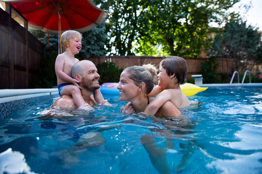 Portrait of smiling family in swimming pool