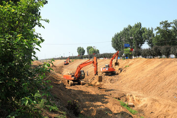 excavators clean up dried up rivers in a rural area, China