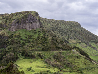 Fototapeta na wymiar Bordões Rock, overview of this imposing rock formation, covered with mosses, lichens and other vegetation. One of the exlíbris of the island of Flores.