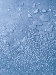 water drops of different sizes on a blue surface, drops texture, rain on blue tile, rain texture, refreshing background, vertical