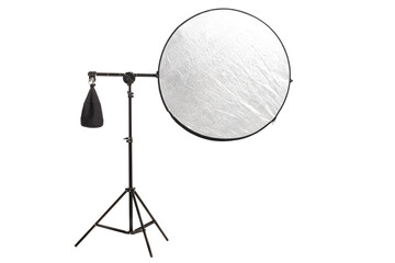 Round silver fabric reflector on stand with counterweight bag. Photography studio equipment isolated on white background.