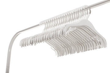 White plastic hangers for clothes hanging on rod from clothing rack. Isolated on white background..