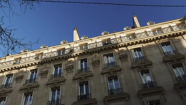 Slow panning to luxury apartment building Haussmannian architecture in central Paris - real estate immo property in central part of the city near Champs Elysee - large French balconies