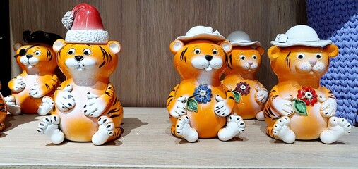 Beautiful figurines of tigers in the store. Cute tiger souvenir.