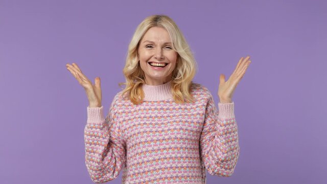 Charismatic smart fancy elderly blonde woman lady 40s years old wears warm shirt show mind explosion isolated on plain pastel light purple background studio portrait. People emotions lifestyle concept