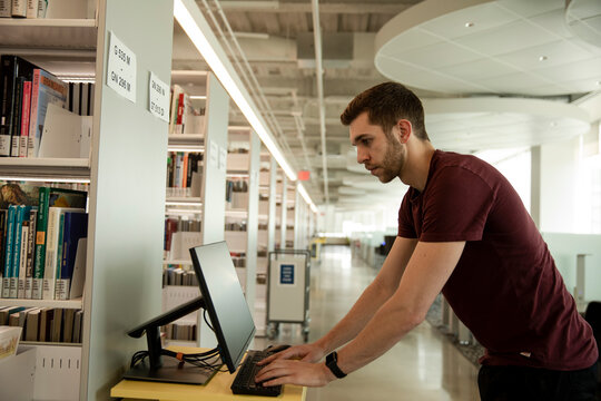 Portrait of student wearing t shirt in library