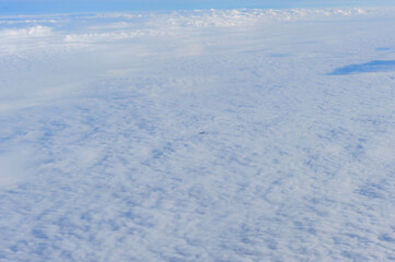 The beautiful scenery of the sea of clouds and the earth through the suspended window on the plane