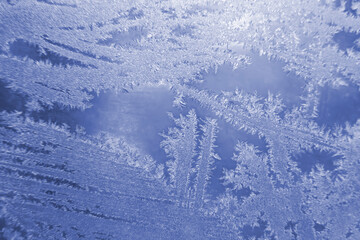 frosty patterns on the window glass closeup. natural textures and backgrounds. ice patterns on frozen